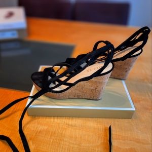 Black wedge leg wrapped sandals by Guess, size 10. Never worn.